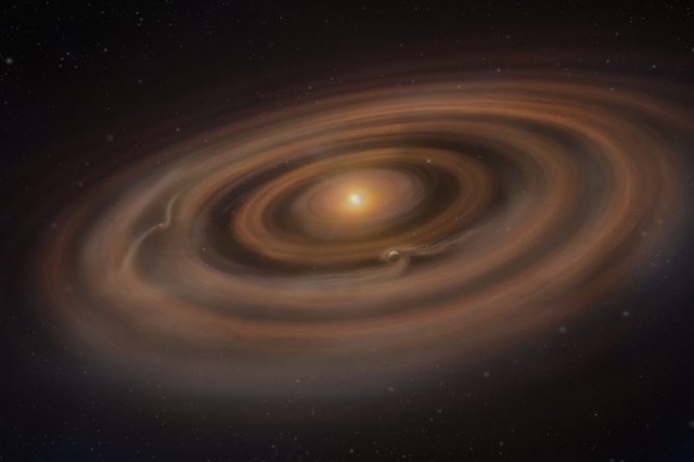 生まれたての惑星の兆候が見られる原始惑星系円盤の想像図