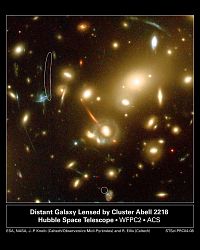 （銀河団Abell 2218と重力レンズ効果を受けた遠方銀河の像を捉えた画像）
