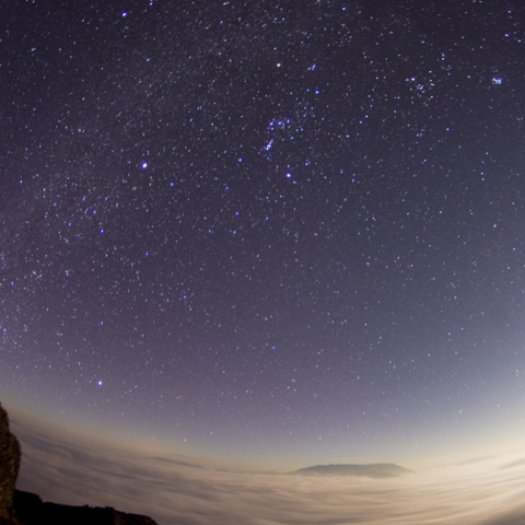 a sea of clouds and milky way