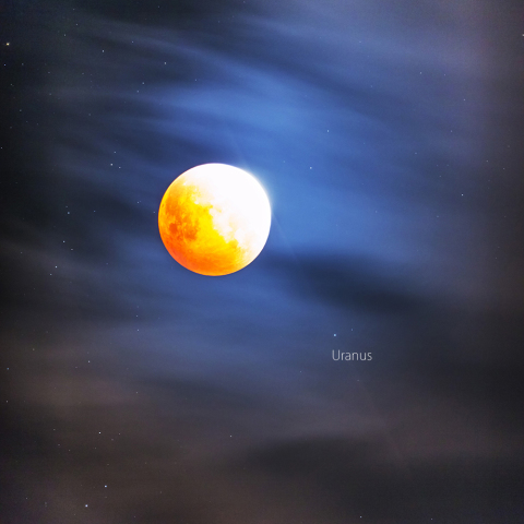 Lunar Eclipse and Uranus over the iridescent clouds.